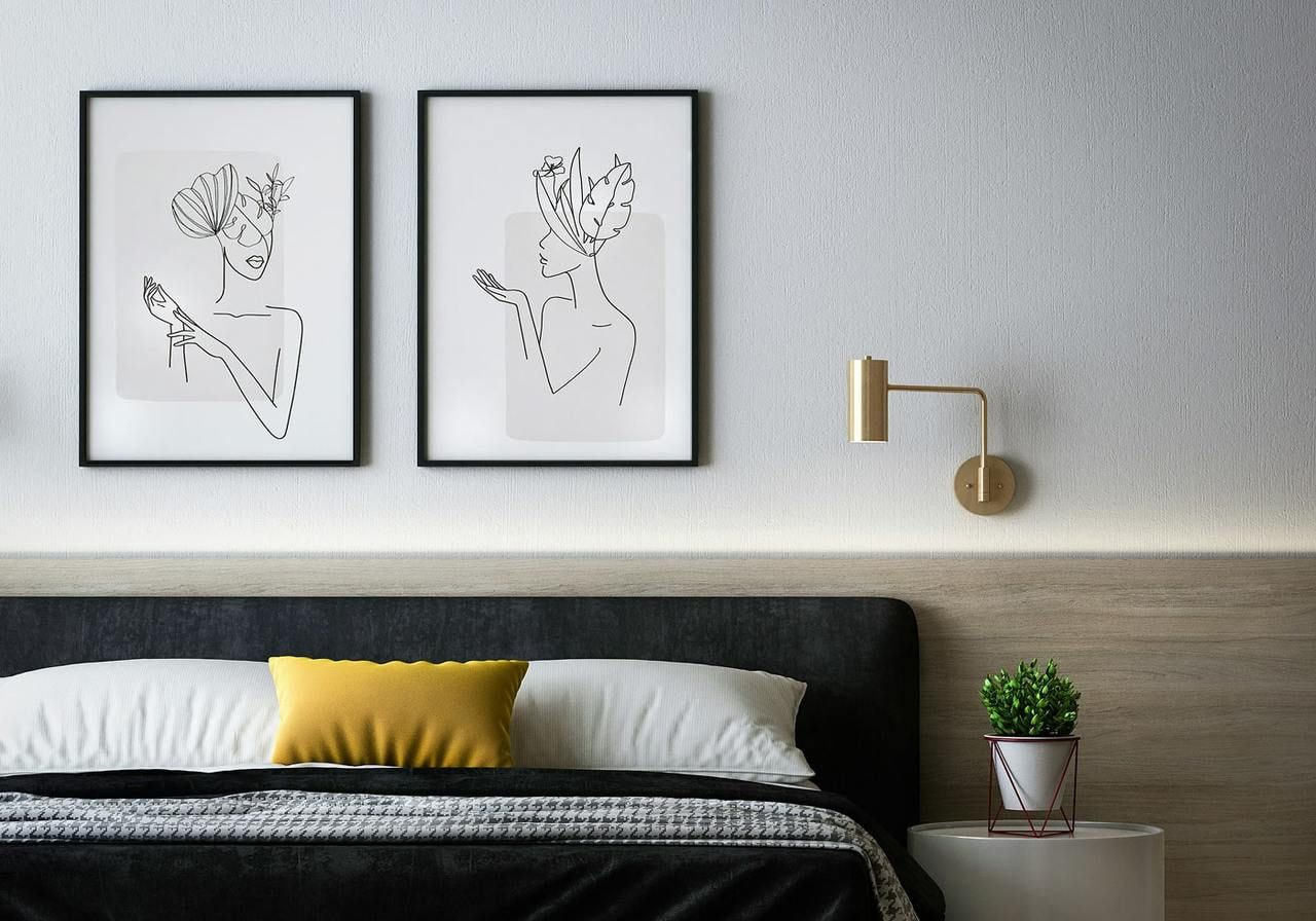 Framed wall art hanging above a bed.